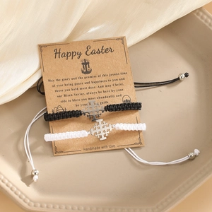 Detail of handmade woven cross bracelets set on gift card for Happy Easter