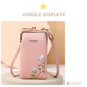 Close-up of pink lychee leather phone bag with white flower embroidery and metal clasp