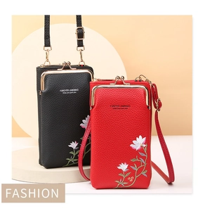 Detail of floral embroidery on lychee textured crossbody phone bag with metal clasp