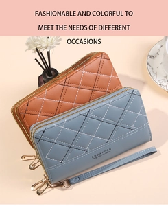 Detail of dual zipper wallets with diamond stitching, wrist straps and elegant accents
