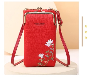 Detail of red litchi texture PU leather phone bag with floral embroidery and kiss lock