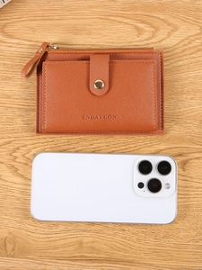 Brown leather women's short wallet with zipper and snap button shown next to a smartphone