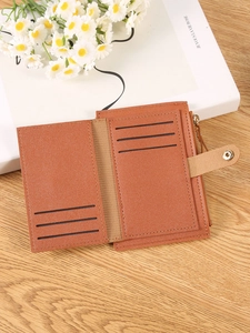 Brown litchi grain leather bifold wallet with card slots on a rustic wooden table