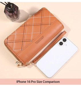 Brown quilted leather phone wallet with heart zipper pull and wrist strap shown by phone