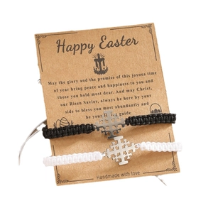Handmade woven cross bracelets in black and white set on vintage display card