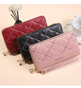 Detailed view of quilted long wallets with dual gold zippers in multiple colors