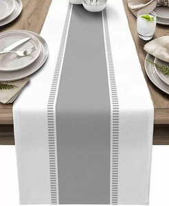 Detail of striped table runner with woven cotton linen texture on a wooden table