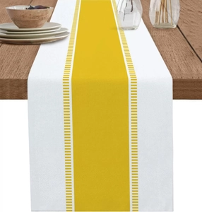 Detail of yellow striped table runner with stitched borders on a dark wood table