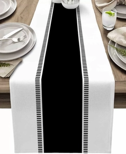 Close-up of geometric striped table runner with woven texture on a wooden dining table