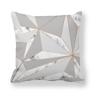 Detail of geometric peach skin cushion cover with marble patterns and gold lines