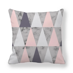 Close-up of peach skin fabric cushion cover with geometric pink grey marble triangles
