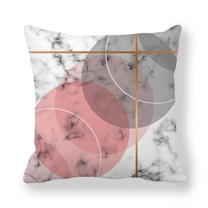 Detail of soft peach skin cushion cover featuring geometric marble and gold ring patterns