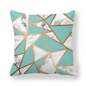 Detail of geometric pillowcase with marble textures and mint green block patterns