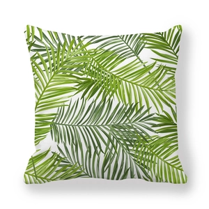 Detailed texture of green palm leaf print on white peach skin fabric cushion cover