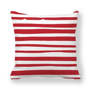 Detailed view of red and white striped peach skin pillowcase with artistic brush textures
