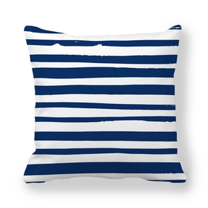 Detail of square pillowcase featuring blue and white artistic horizontal stripes