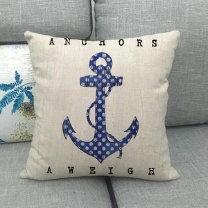 Nautical style square anchor throw pillow cover on grey sofa with Anchors Aweigh print