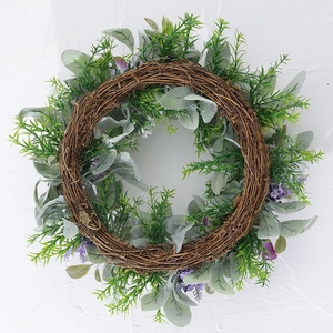Artificial wreath with purple rabbit ear grass and green leaves on natural vine base