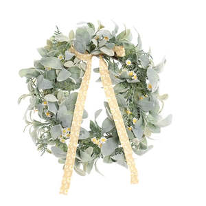 Couronne de pâquerettes printanière avec feuilles vertes et ruban floral jaune