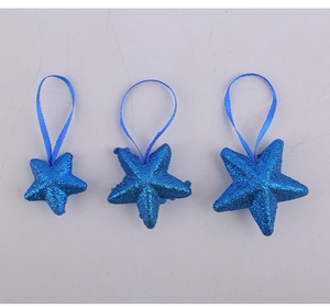 Three blue glittery star ornaments in different sizes for Fourth of July celebrations