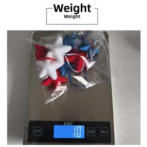 Close-up of lightweight Fourth of July star ornaments on a scale weighing 10 grams