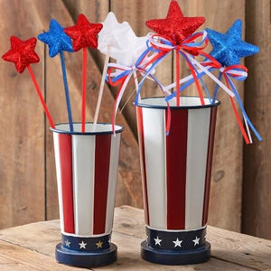 Patriotic star decorations in red, white, and blue metal buckets for home festivities