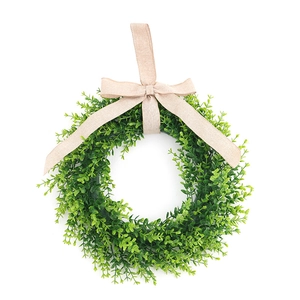 Artificial eucalyptus wreath with burlap bow for front door home decor on white background