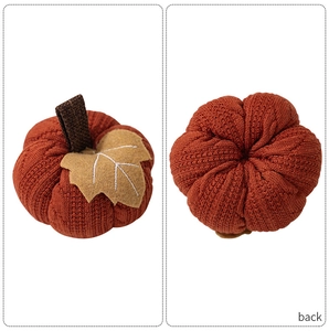 Detailed knit texture of a brick red autumn pumpkin decor with a dark brown stem