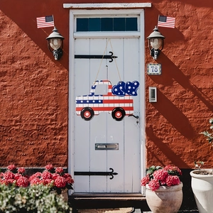 Detail view of Independence Day wood truck door sign hanging on a white vintage door