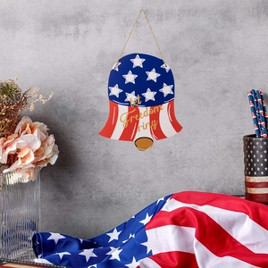 Close-up of wooden bell door sign with American flag and Let Freedom Ring text