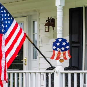 Detail of wooden liberty bell hanger with Let Freedom Ring text on American flag pattern
