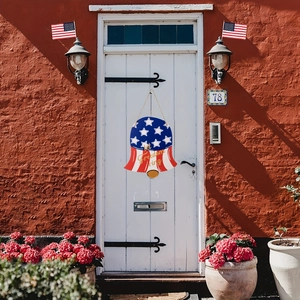 Detail view of independence day bell sign with Let Freedom Ring text on white door