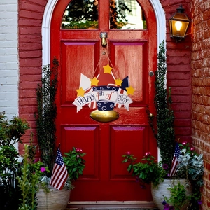 Detail of Happy 4th of July wooden door sign hanging on a vintage red arch door