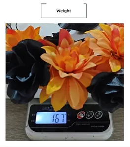 Close-up showing a Halloween wreath weight of 167g on a digital scale for detail