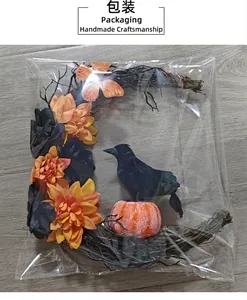 Halloween crescent wreath with black raven and pumpkin in clear protective packaging