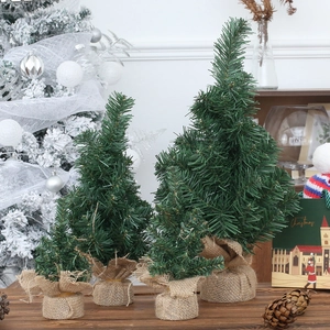 Mini artificial Christmas trees set with rustic burlap bases for holiday tabletop decor