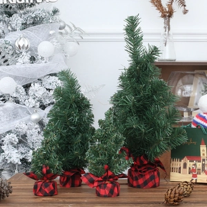 Set of four mini artificial Christmas trees with buffalo plaid base for tabletop decor