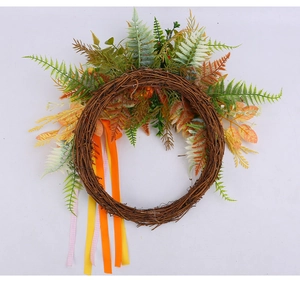Detail of harvest wreath with faux ferns and colorful ribbons on natural rattan base