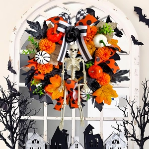 Halloween wreath with white skeleton, orange pumpkins and autumn maple leaves decor