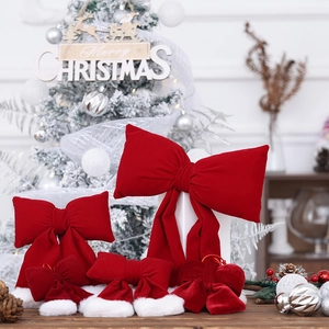 Large red velvet Christmas bows with plush white trim for festive holiday tree decoration