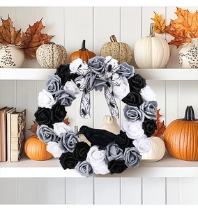 Detail of gothic Halloween wreath with black and white roses and a realistic black crow