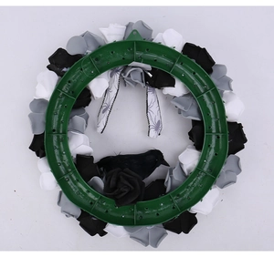 Detail of Halloween wreath back showing a durable green plastic bracket and silk roses