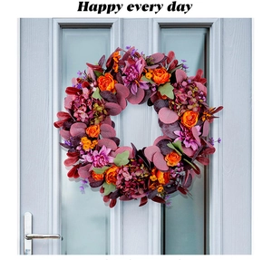 Detail of vibrant autumn wreath with silk peonies and hydrangeas on a modern wooden door