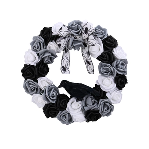 Halloween wreath with black and white roses, spider bow, and crow for party door decoration