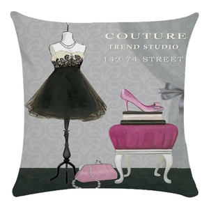 Detail of square pillowcase featuring black couture dress and pink accessories illustration