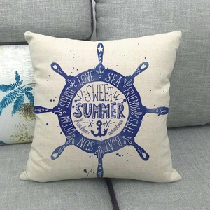 Linen decorative nautical pillow cover with blue ship wheel print on grey sofa