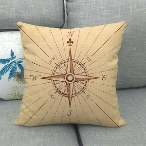 Linen decorative pillow cover with vintage nautical compass pattern on gray sofa