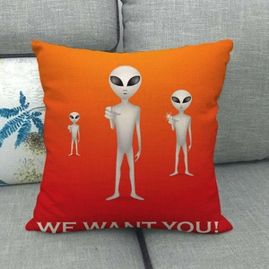 Detail of linen alien pillow case with We Want You slogan on a gray sofa