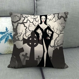 Detail of linen cushion cover featuring a Gothic girl design on a grey fabric sofa