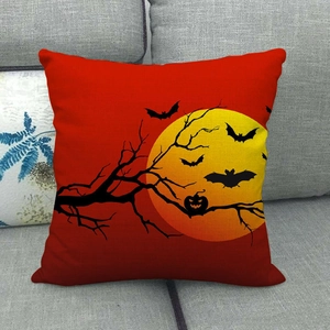 Close-up of linen Halloween pillowcase with full moon and pumpkin on a gray sofa